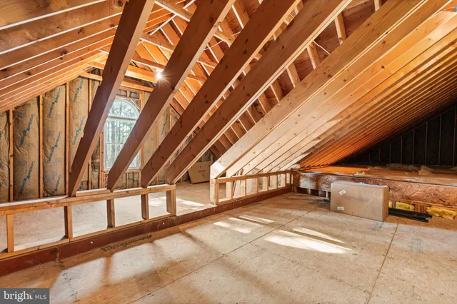a view of a wooden chairs and table in the balcony