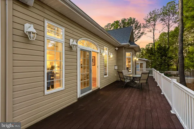 a balcony with wooden floor and furniture