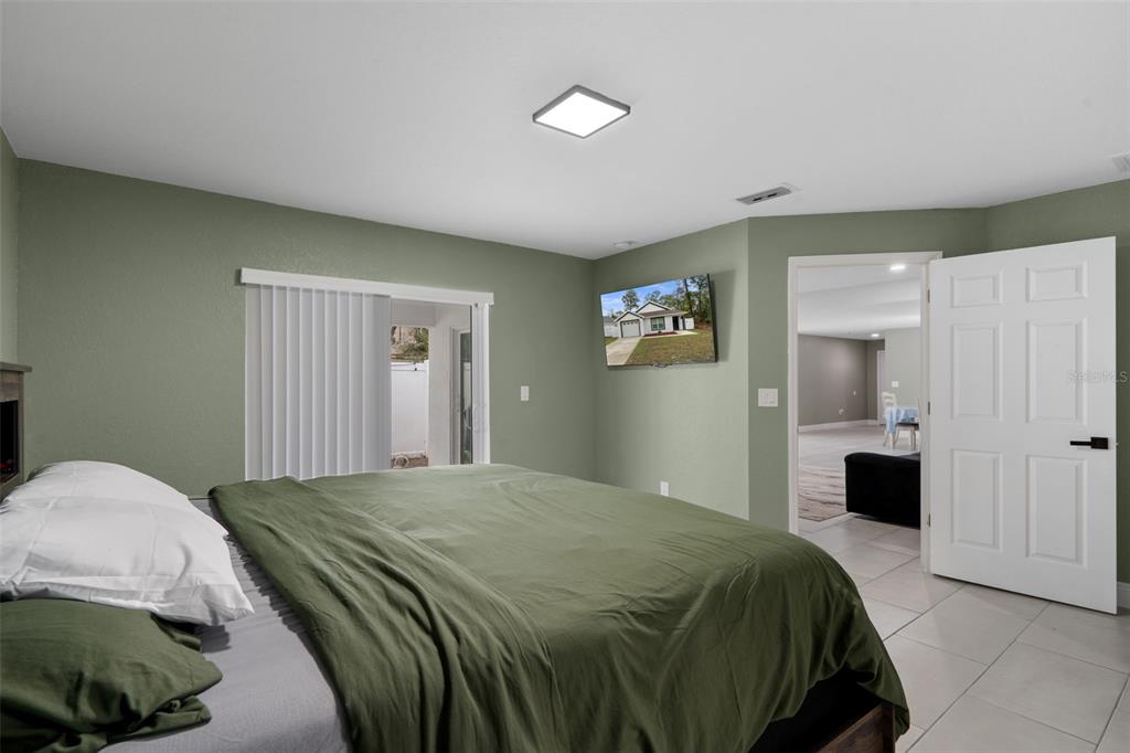 5106 Pacific Avenue Spring Hill, FL 34606 - Photo 12 of 23 a bedroom with a bed and a walk in closet