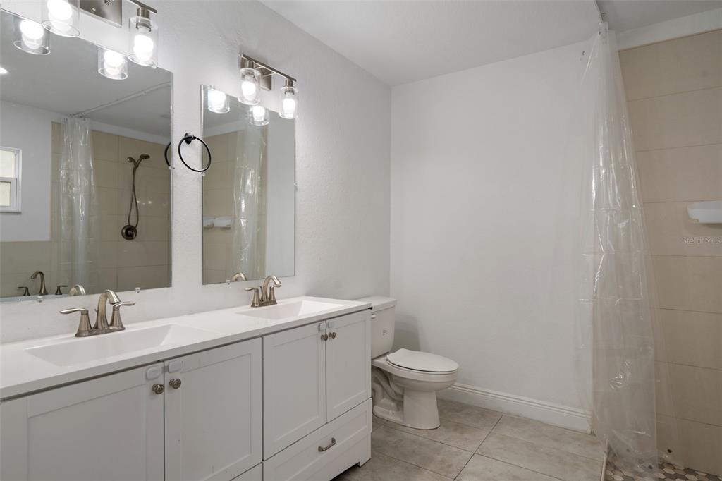 5106 Pacific Avenue Spring Hill, FL 34606 - Photo 14 of 23 a bathroom with a toilet sink and mirror