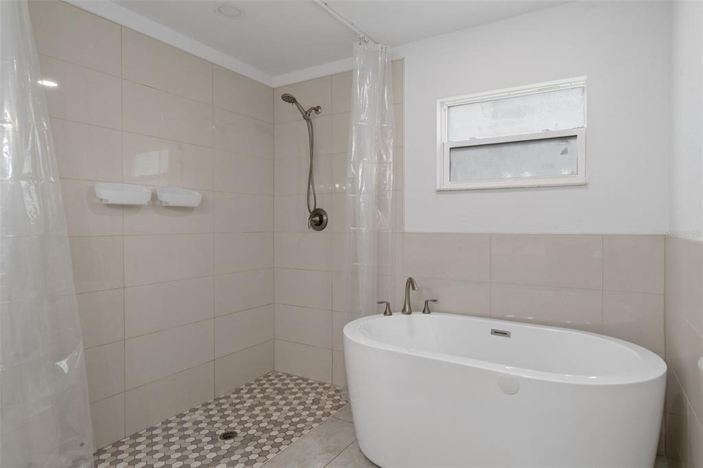 5106 Pacific Avenue Spring Hill, FL 34606 - Photo 15 of 23 a white bath tub sitting in a bathroom