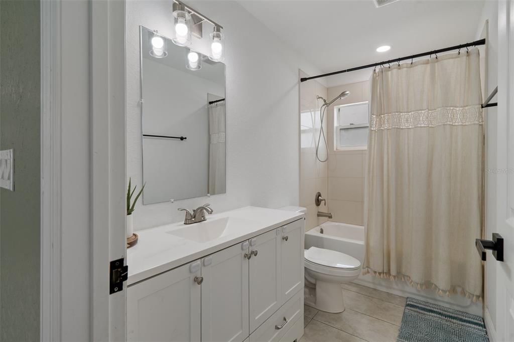 5106 Pacific Avenue Spring Hill, FL 34606 - Photo 18 of 23 a bathroom with a double vanity sink toilet and shower