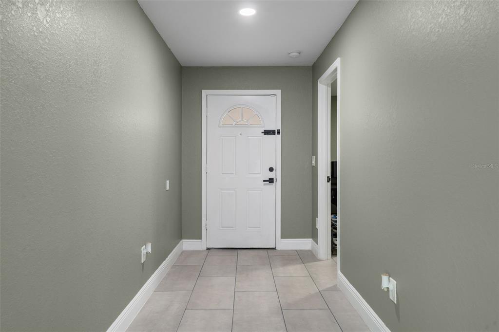 5106 Pacific Avenue Spring Hill, FL 34606 - Photo 4 of 23 wooden floor in a hall with a window