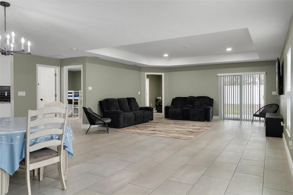 5106 Pacific Avenue Spring Hill, FL 34606 - Photo 6 of 23 a living room with furniture a dining table and chairs