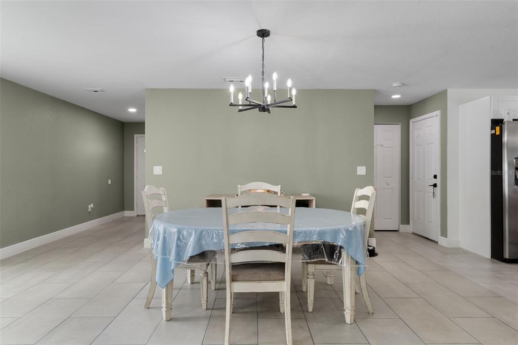 5106 Pacific Avenue Spring Hill, FL 34606 - Photo 8 of 23 a view of a dining room with furniture and chandelier
