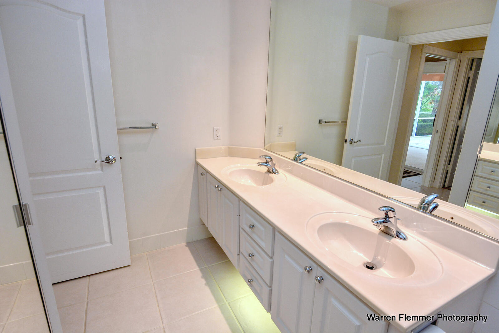 1044 Southwest Balmoral Trace Stuart, FL 34997 - Photo 17 of 34 a bathroom with a double vanity sink and mirror