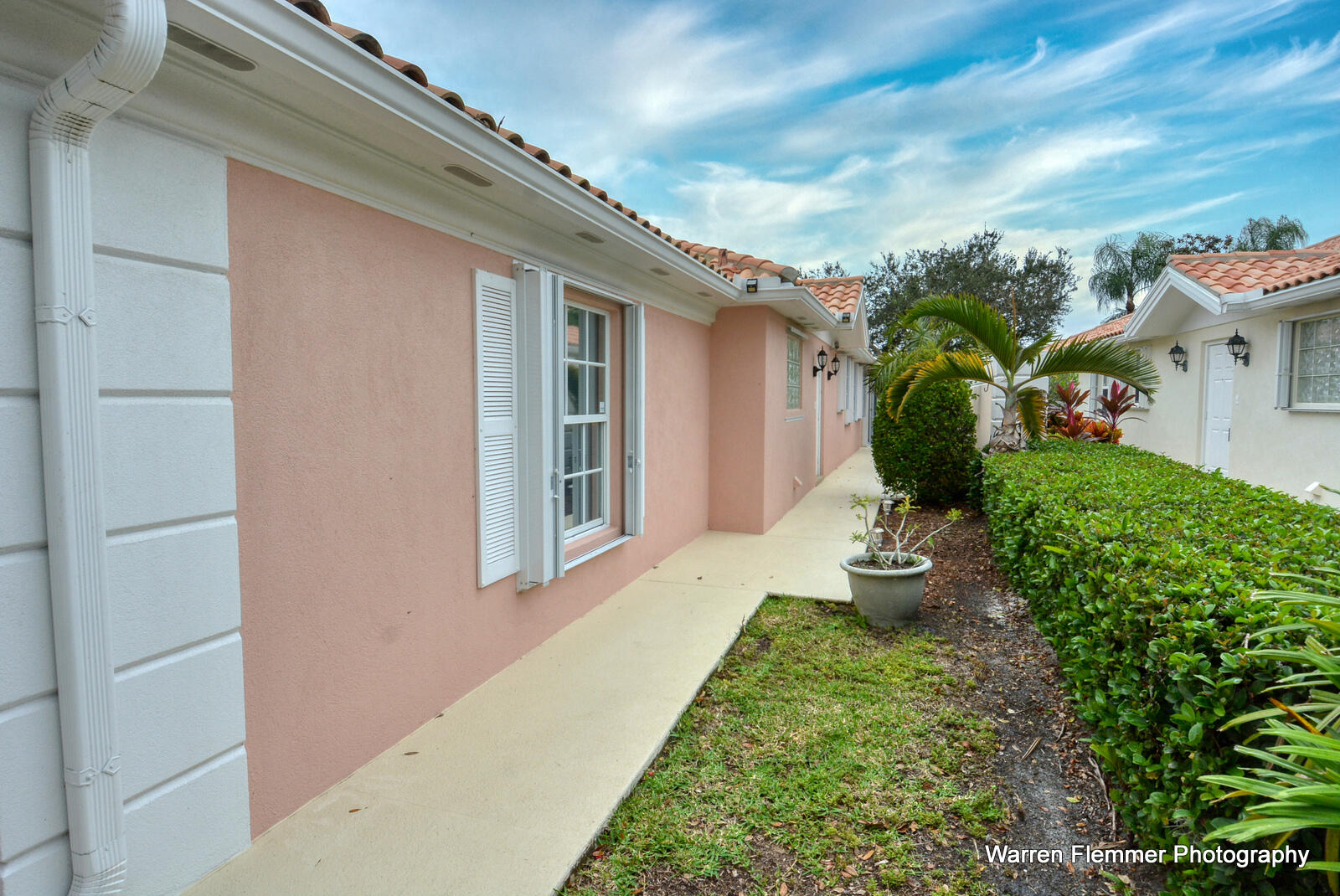 1044 Southwest Balmoral Trace Stuart, FL 34997 - Photo 2 of 34 a front view of a house with a yard
