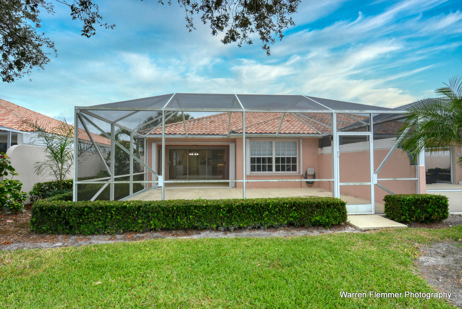 1044 Southwest Balmoral Trace Stuart, FL 34997 - Photo 26 of 34 a front view of a house with a garden