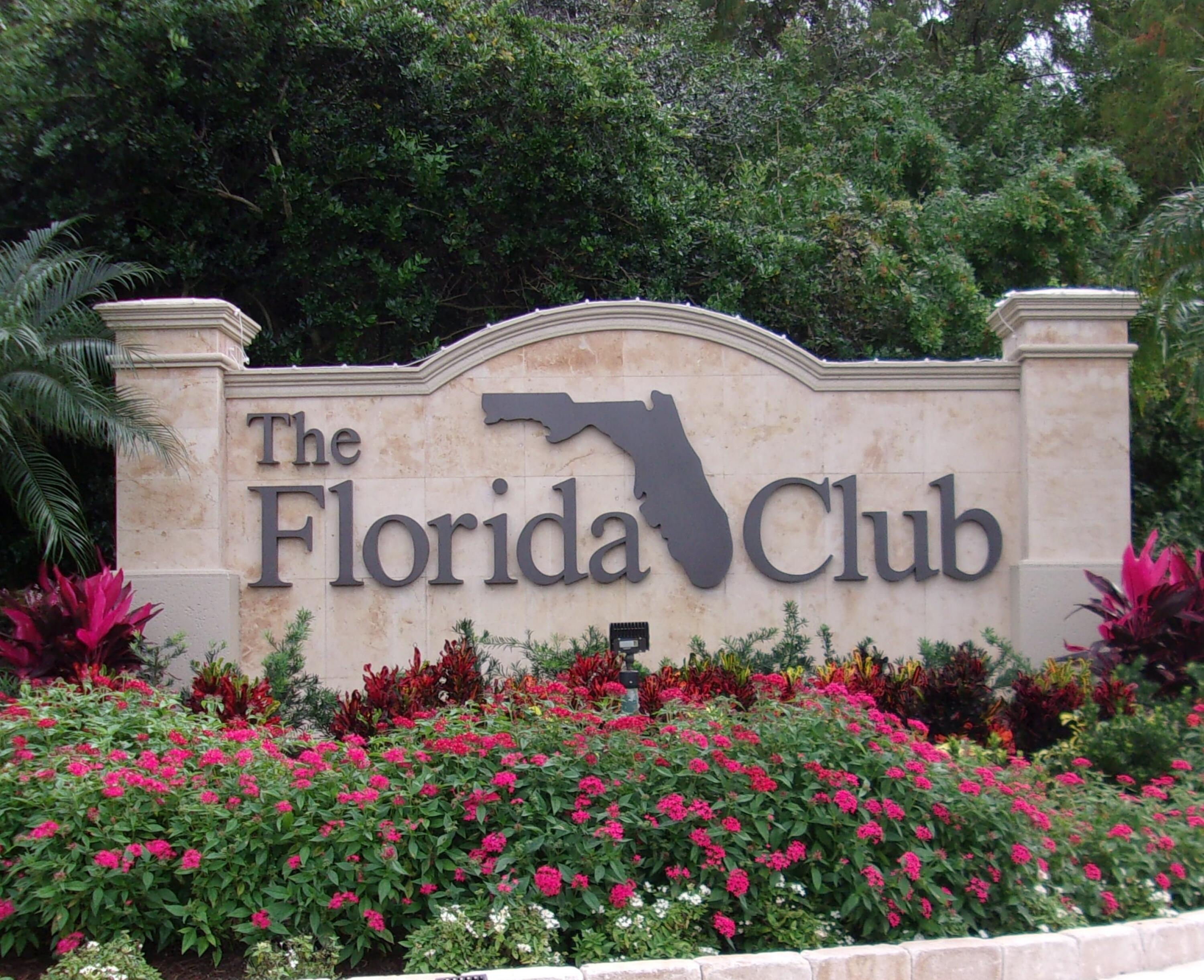 1044 Southwest Balmoral Trace Stuart, FL 34997 - Photo 27 of 34 a view of sign board with plants and flowers