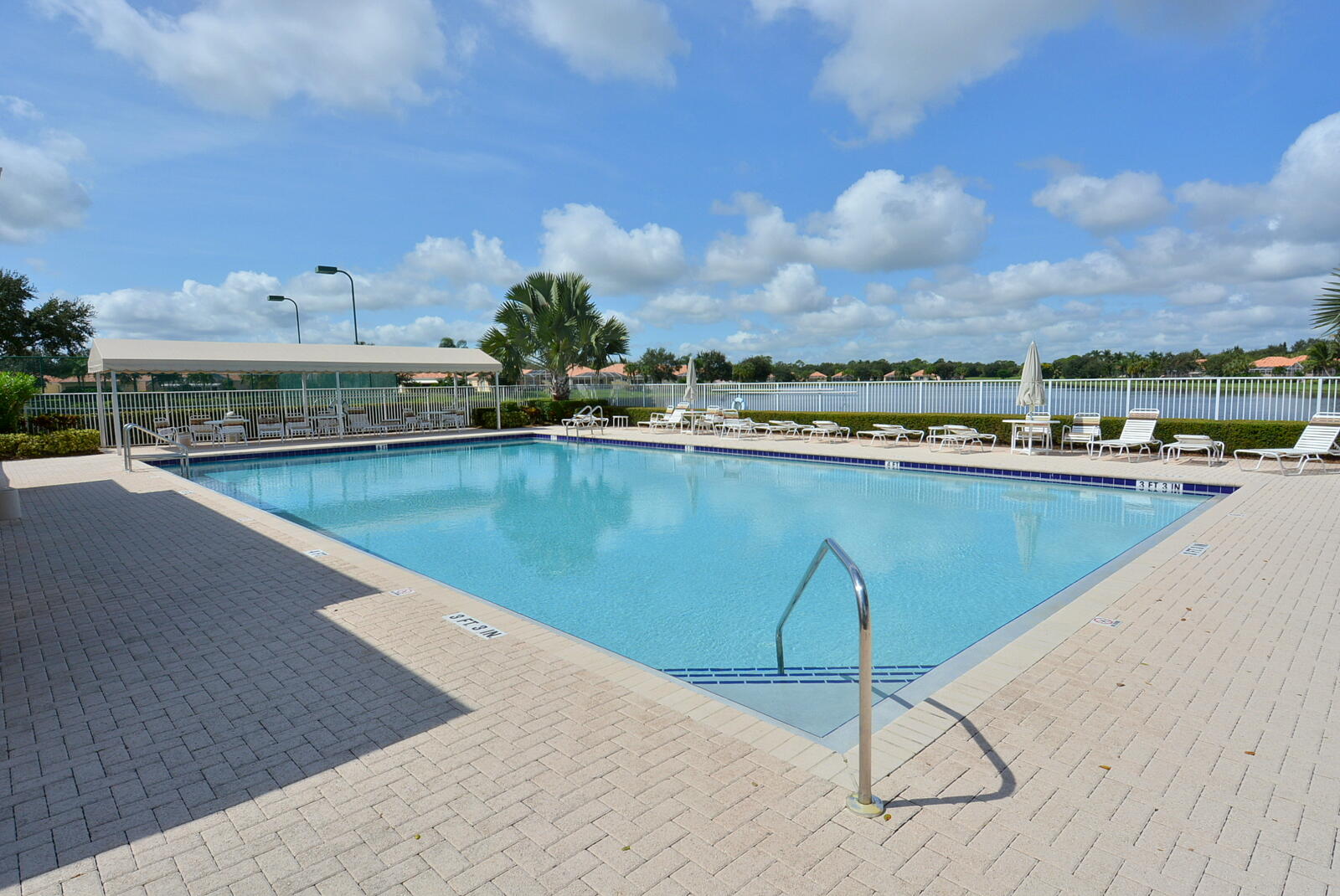 1044 Southwest Balmoral Trace Stuart, FL 34997 - Photo 30 of 34 a view of a swimming pool with a terrace