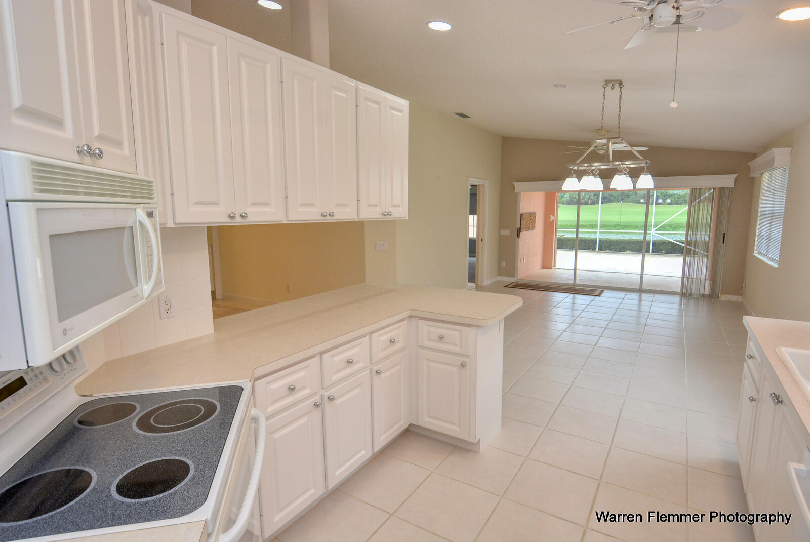 1044 Southwest Balmoral Trace Stuart, FL 34997 - Photo 6 of 34 a kitchen with a sink a stove and cabinets