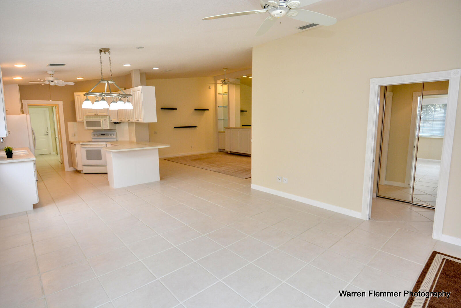 1044 Southwest Balmoral Trace Stuart, FL 34997 - Photo 10 of 34 a view of a kitchen with kitchen island stainless steel appliances refrigerator sink and fireplace