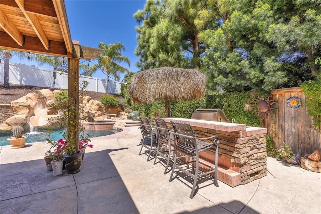30152 Corte Carrizo Temecula, CA 92591 - Photo 31 of 45 a view of a patio with table and chairs potted plants with wooden fence