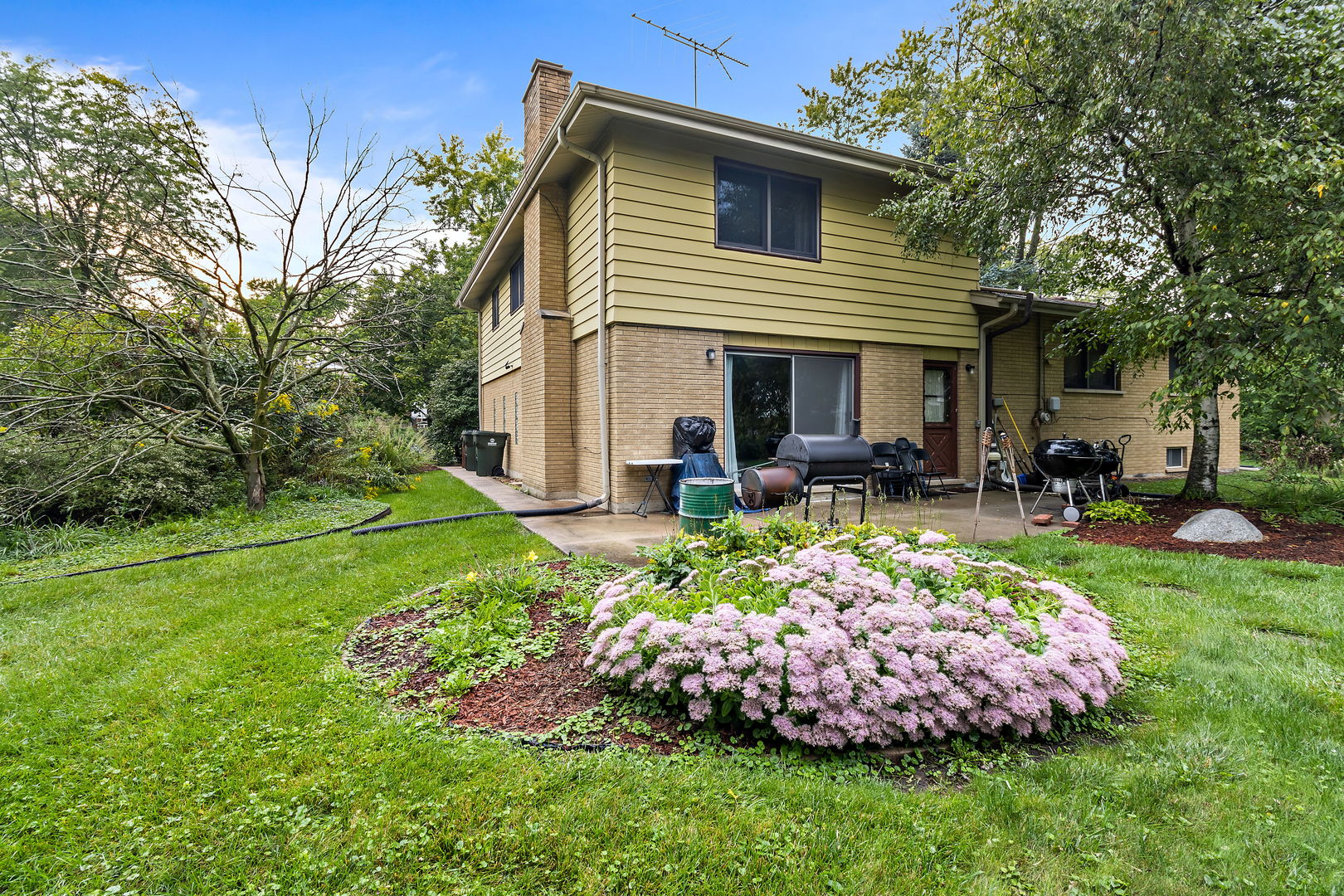 18807 Delta Road Homewood, IL 60430 - Photo 16 of 16 a front view of a house with garden and patio