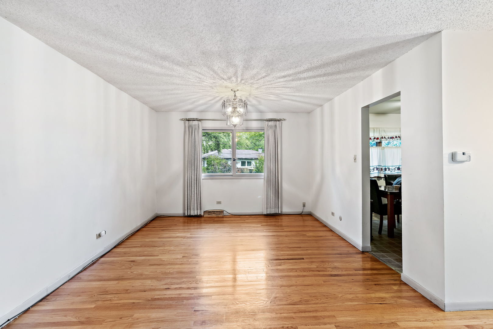 18807 Delta Road Homewood, IL 60430 - Photo 4 of 16 an empty room with windows and entrance