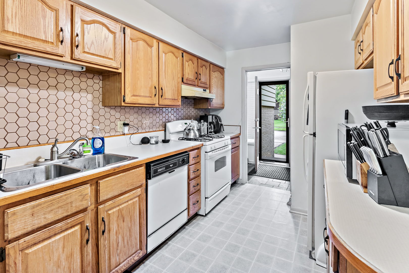 18807 Delta Road Homewood, IL 60430 - Photo 6 of 16 a kitchen with stainless steel appliances granite countertop a sink and cabinets