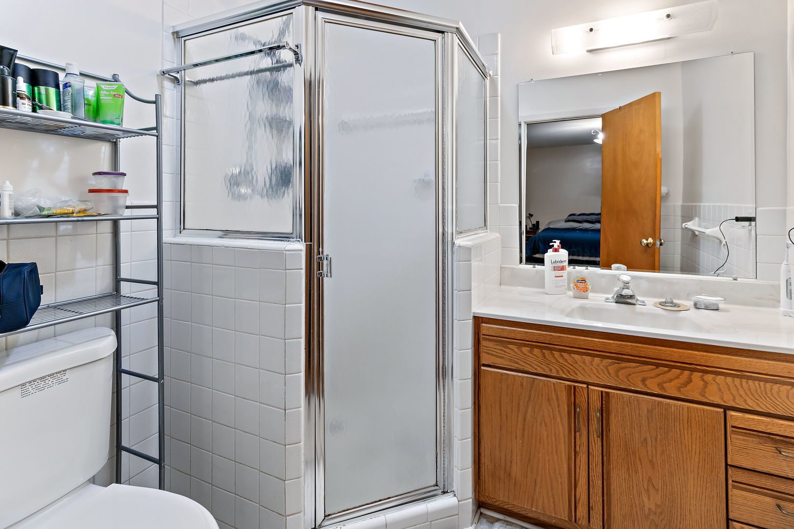 18807 Delta Road Homewood, IL 60430 - Photo 10 of 16 a bathroom with a shower sink and mirror