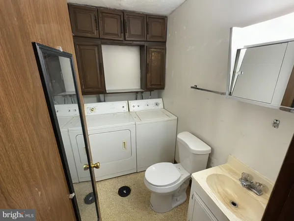 a bathroom with a toilet sink and mirror