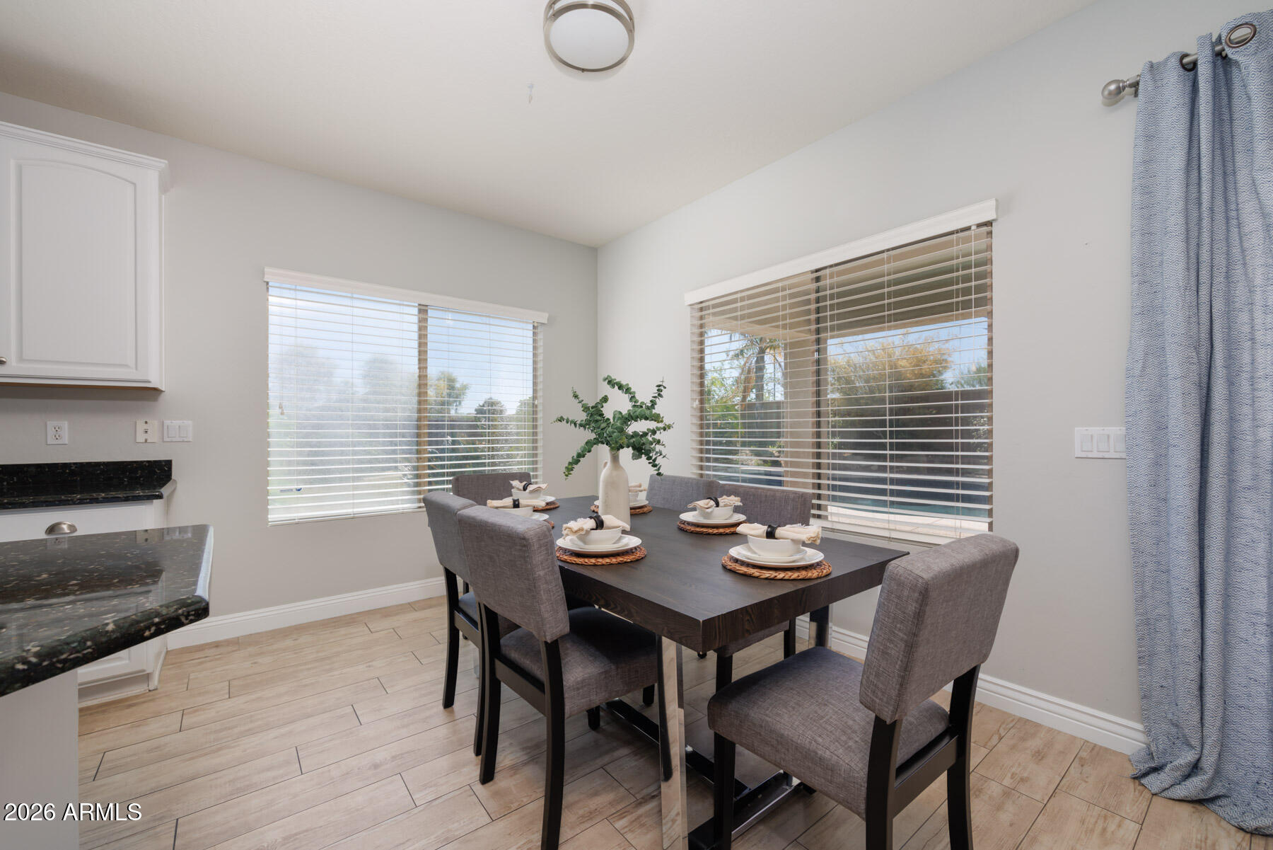 3167 East Powell Way Gilbert, AZ 85298 - Photo 12 of 39 a view of a dining room with furniture window and wooden floor