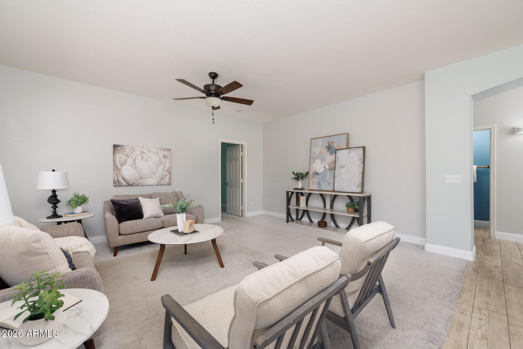 3167 East Powell Way Gilbert, AZ 85298 - Photo 17 of 39 a living room with furniture a chandelier and a table