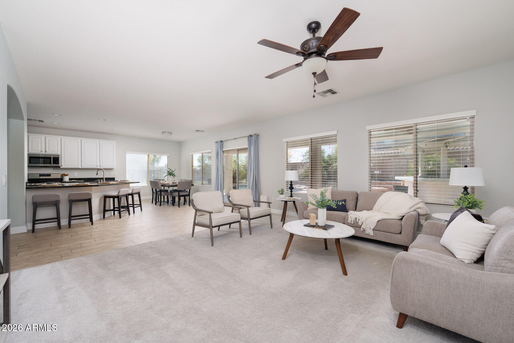 3167 East Powell Way Gilbert, AZ 85298 - Photo 18 of 39 a living room with furniture and a large window with garden view