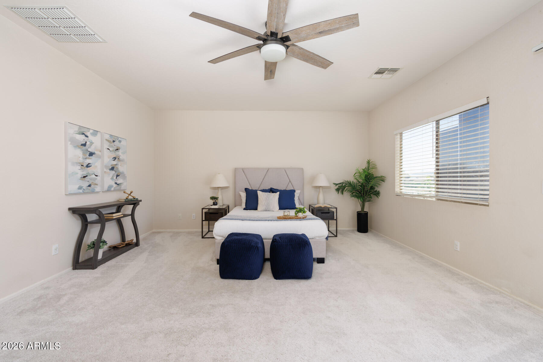 3167 East Powell Way Gilbert, AZ 85298 - Photo 19 of 39 a spacious bedroom with furniture and a window