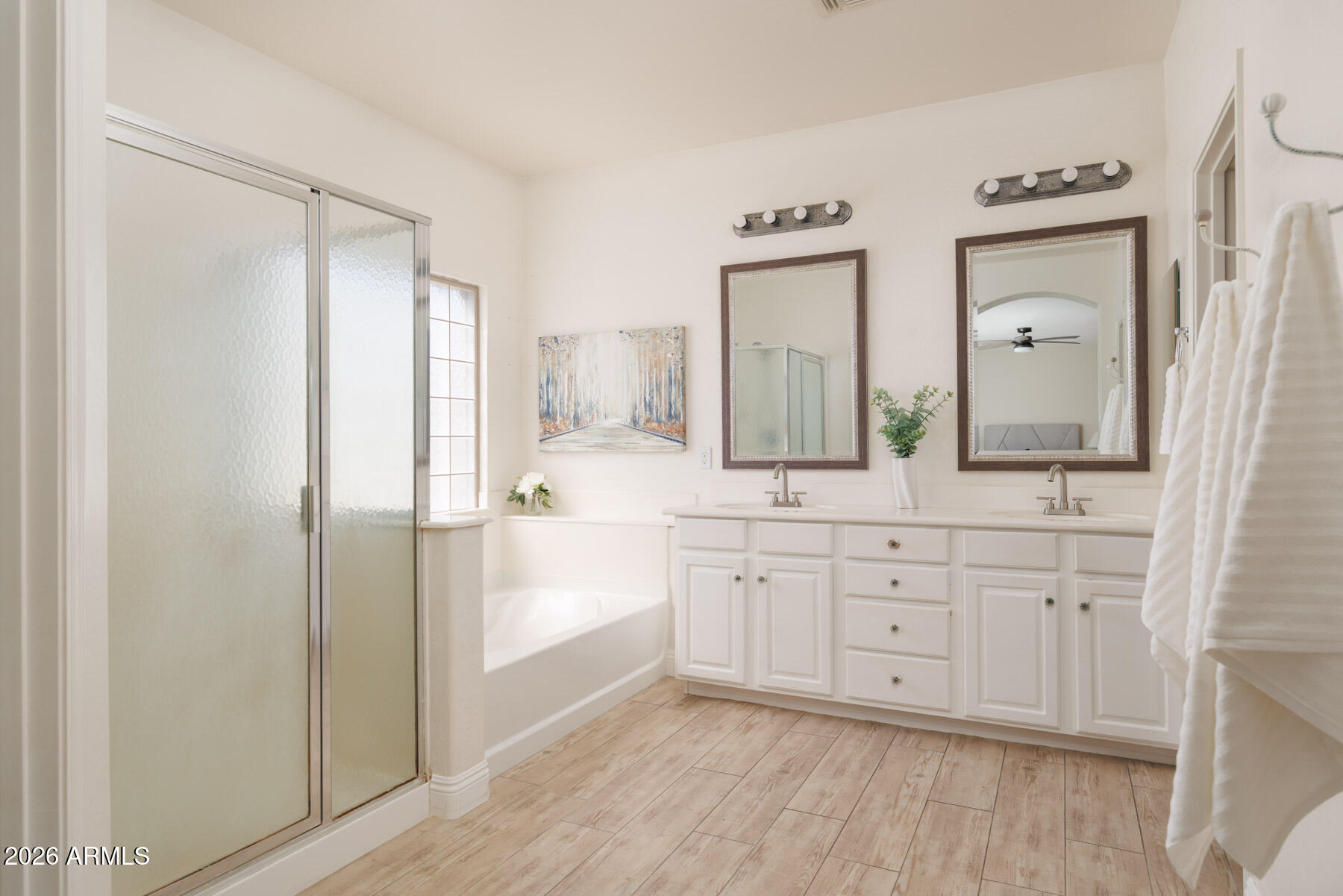 3167 East Powell Way Gilbert, AZ 85298 - Photo 22 of 39 a spacious bathroom with a double vanity sink a mirror and a shower