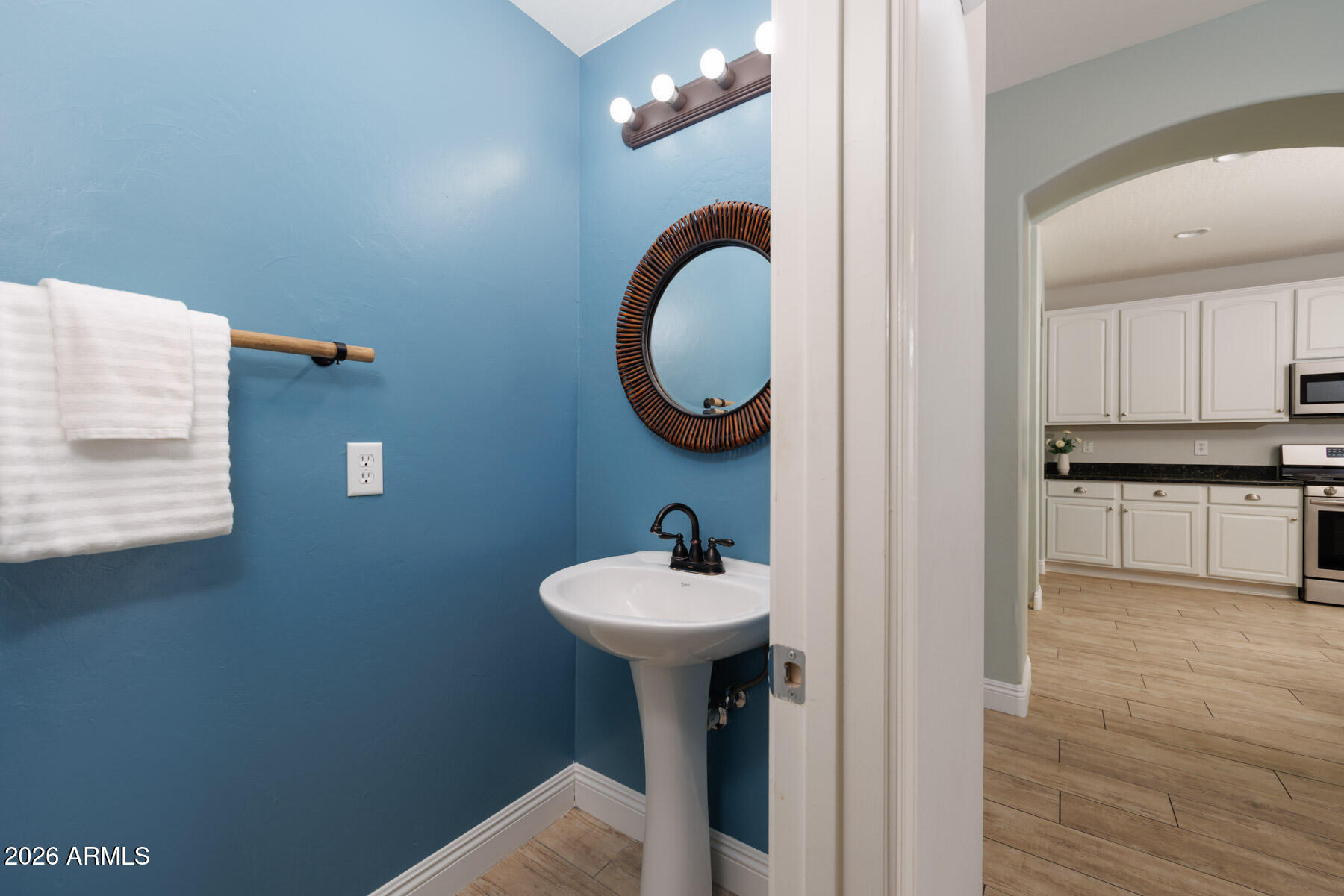 3167 East Powell Way Gilbert, AZ 85298 - Photo 28 of 39 a bathroom with a sink a mirror and a light fixture