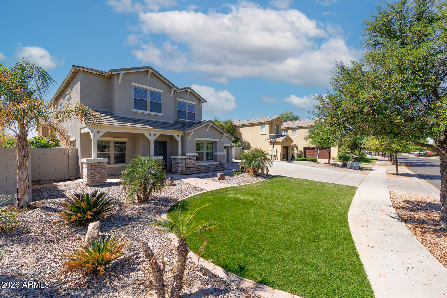 3167 East Powell Way Gilbert, AZ 85298 - Photo 31 of 39 a front view of a house with a yard table and chairs