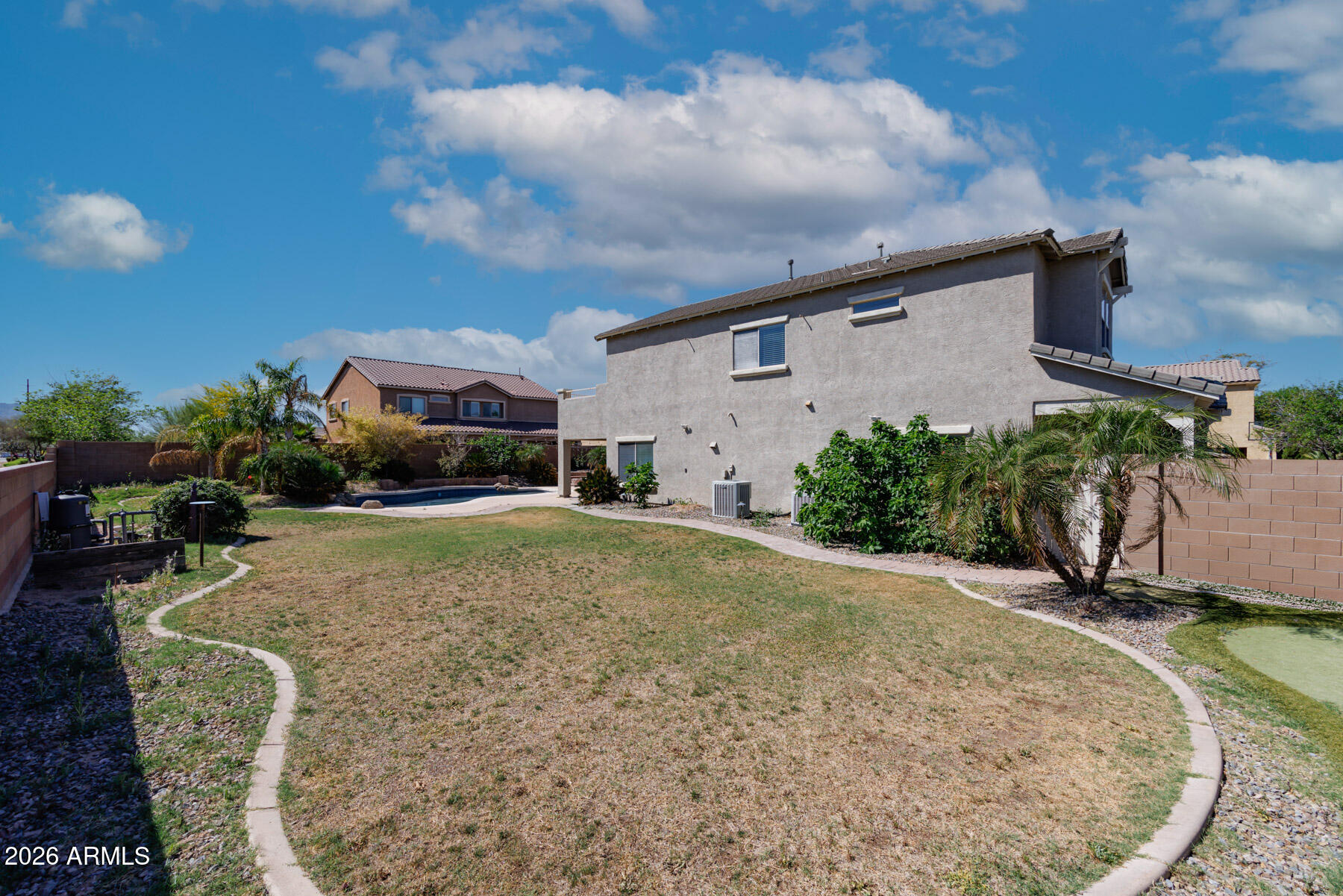 3167 East Powell Way Gilbert, AZ 85298 - Photo 33 of 39 a backyard of a house with yard and outdoor seating