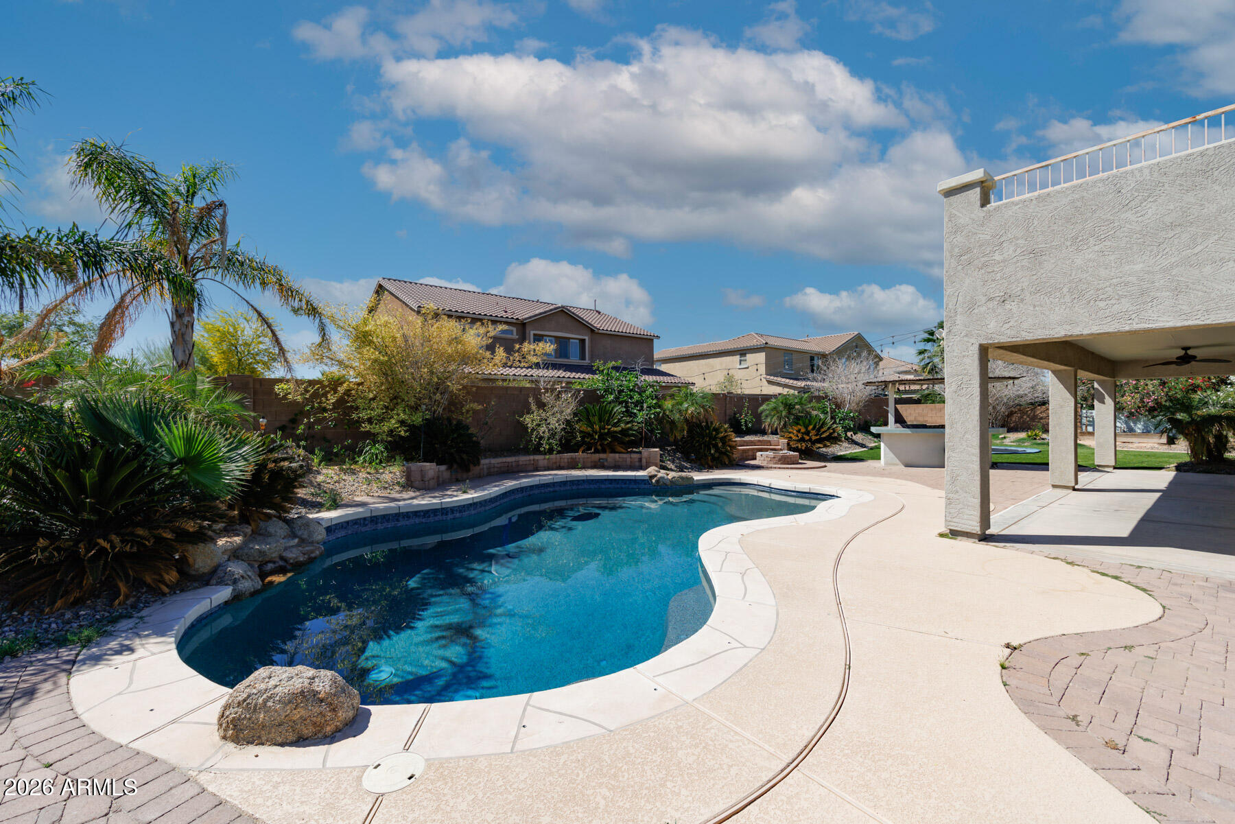 3167 East Powell Way Gilbert, AZ 85298 - Photo 4 of 39 a swimming pool with outdoor seating and plants