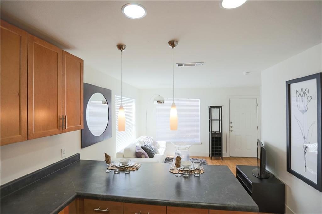 711 West 32nd Street, Unit 119 Austin, TX 78705 - Photo 8 of 23 a view of a very nice looking dining room with a table and chairs