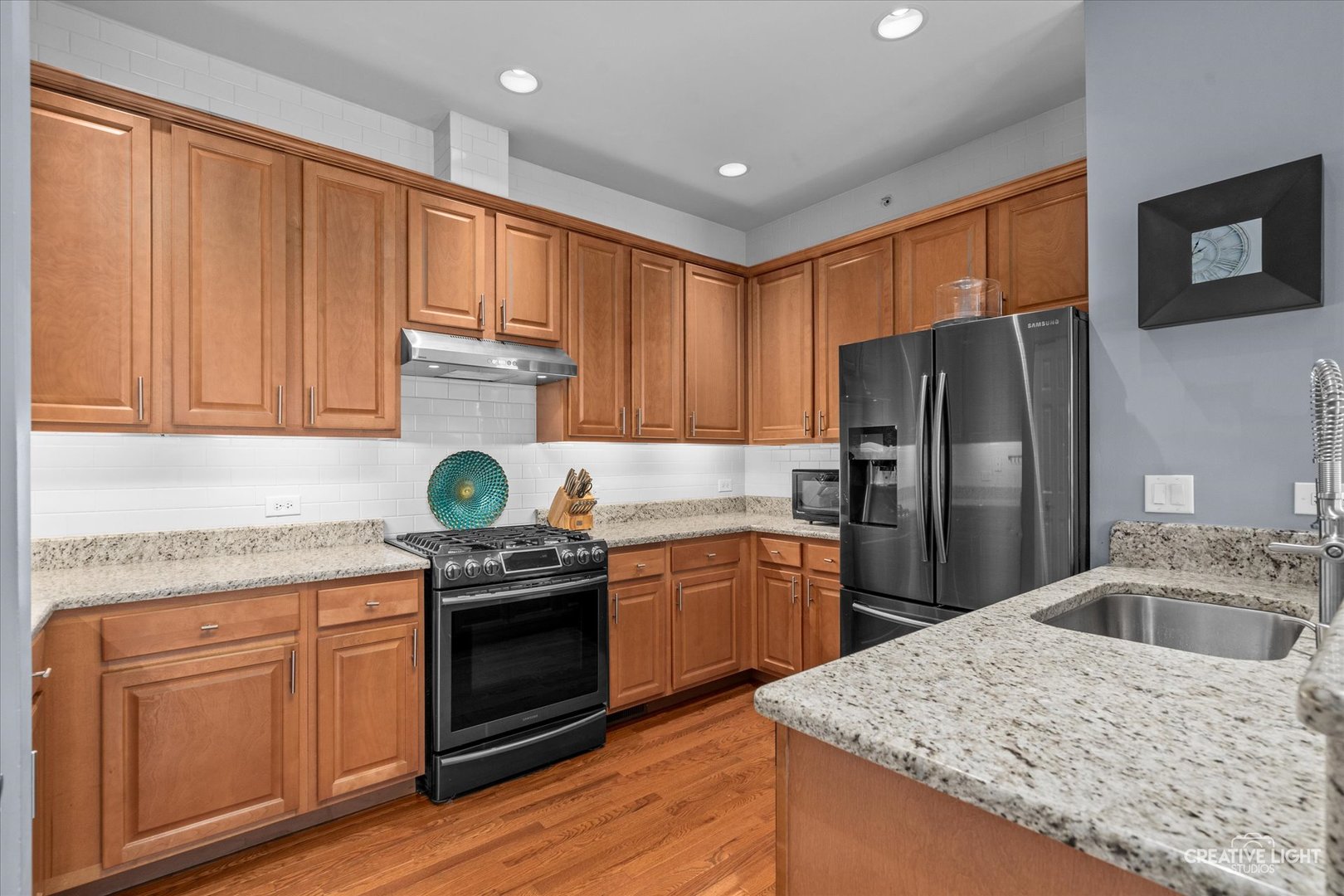 394 Broadmoor Lane Bartlett, IL 60103 - Photo 8 of 18 a kitchen with granite countertop stainless steel appliances and wooden cabinets