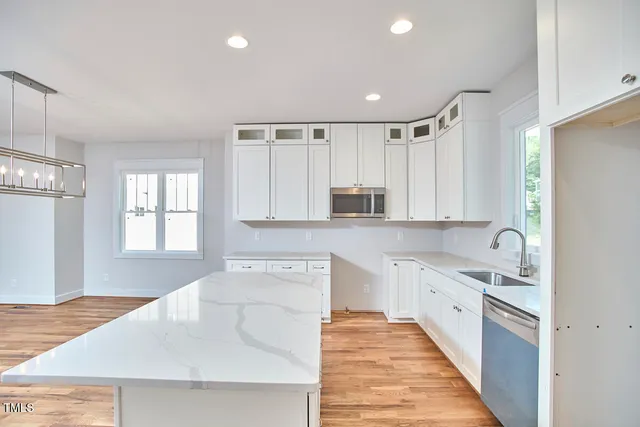a kitchen with granite countertop a sink and cabinets