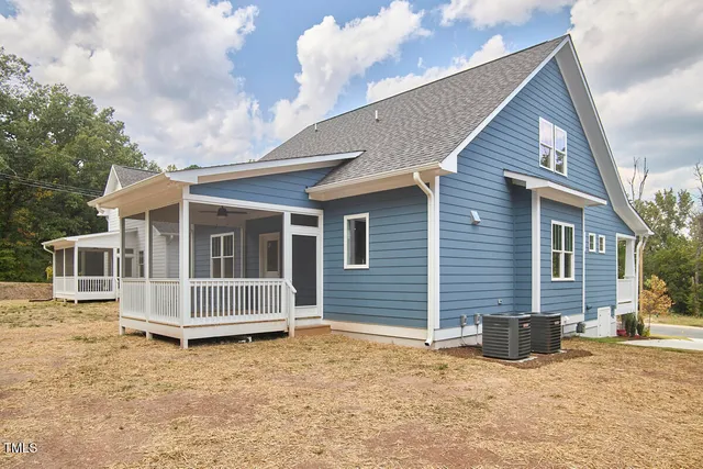 a view of house with backyard and glass door