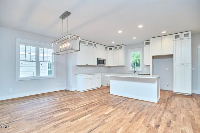 a view of a livingroom with wooden floor and cabinet