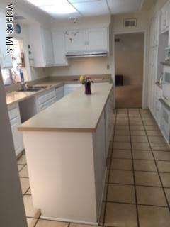 1065 Warwick Avenue Thousand Oaks, CA 91360 - Photo 7 of 15 a kitchen with a sink a stove and cabinets