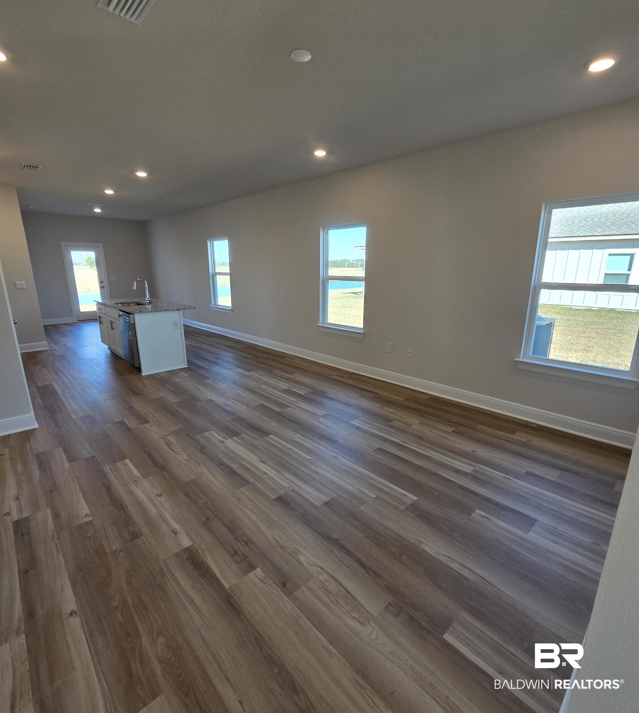 28133 Hallow Trail Elberta, AL 36530 - Photo 6 of 20 Unfurnished living room with dark wood-style floors and recessed lighting