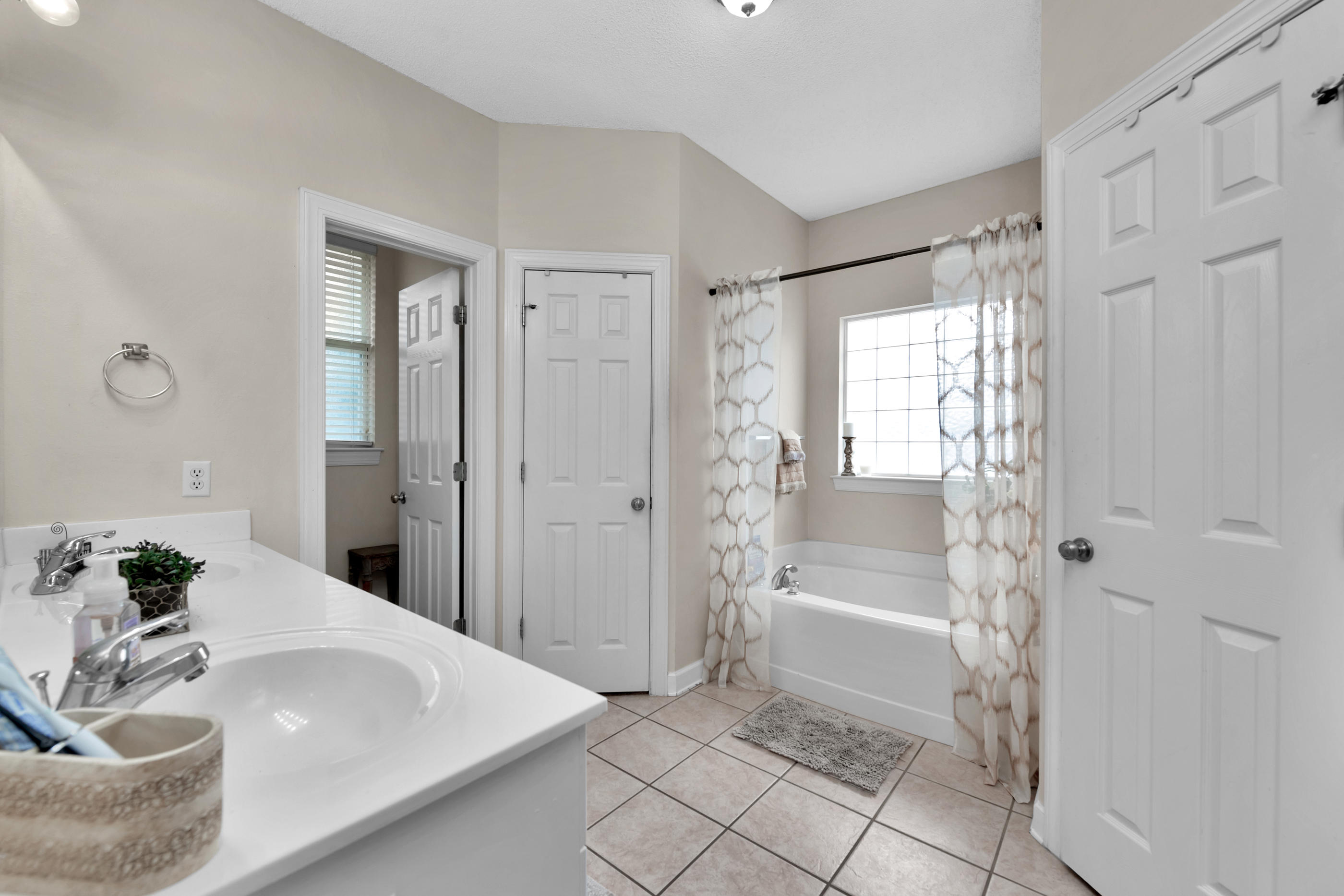 4061 Drifting Sand Trail Destin, FL 32541 - Photo 17 of 32 a spacious bathroom with a bathtub and shower