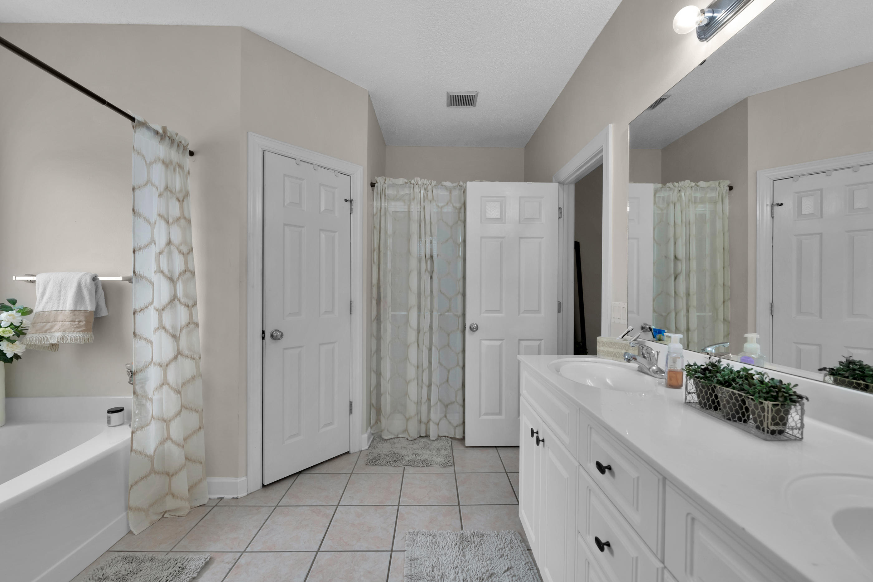 4061 Drifting Sand Trail Destin, FL 32541 - Photo 18 of 32 a bathroom with a double vanity sink toilet and shower