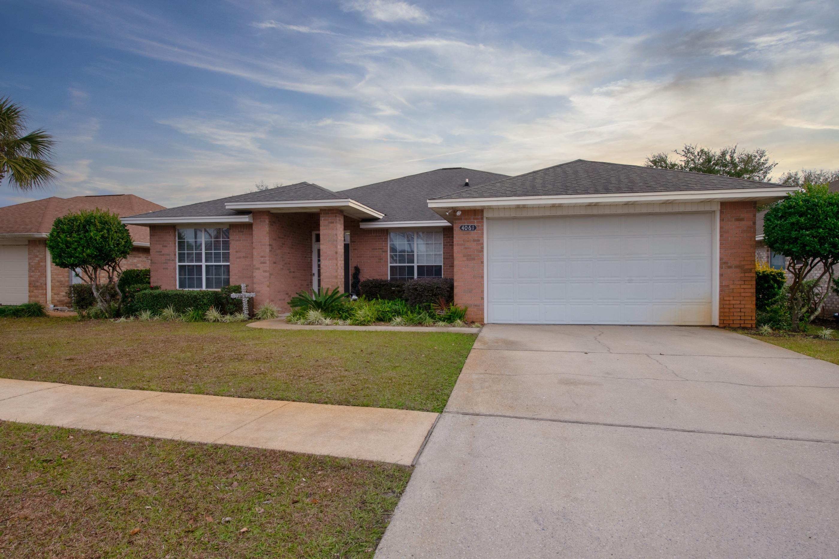 4061 Drifting Sand Trail Destin, FL 32541 - Photo 2 of 32 a front view of house with yard and green space