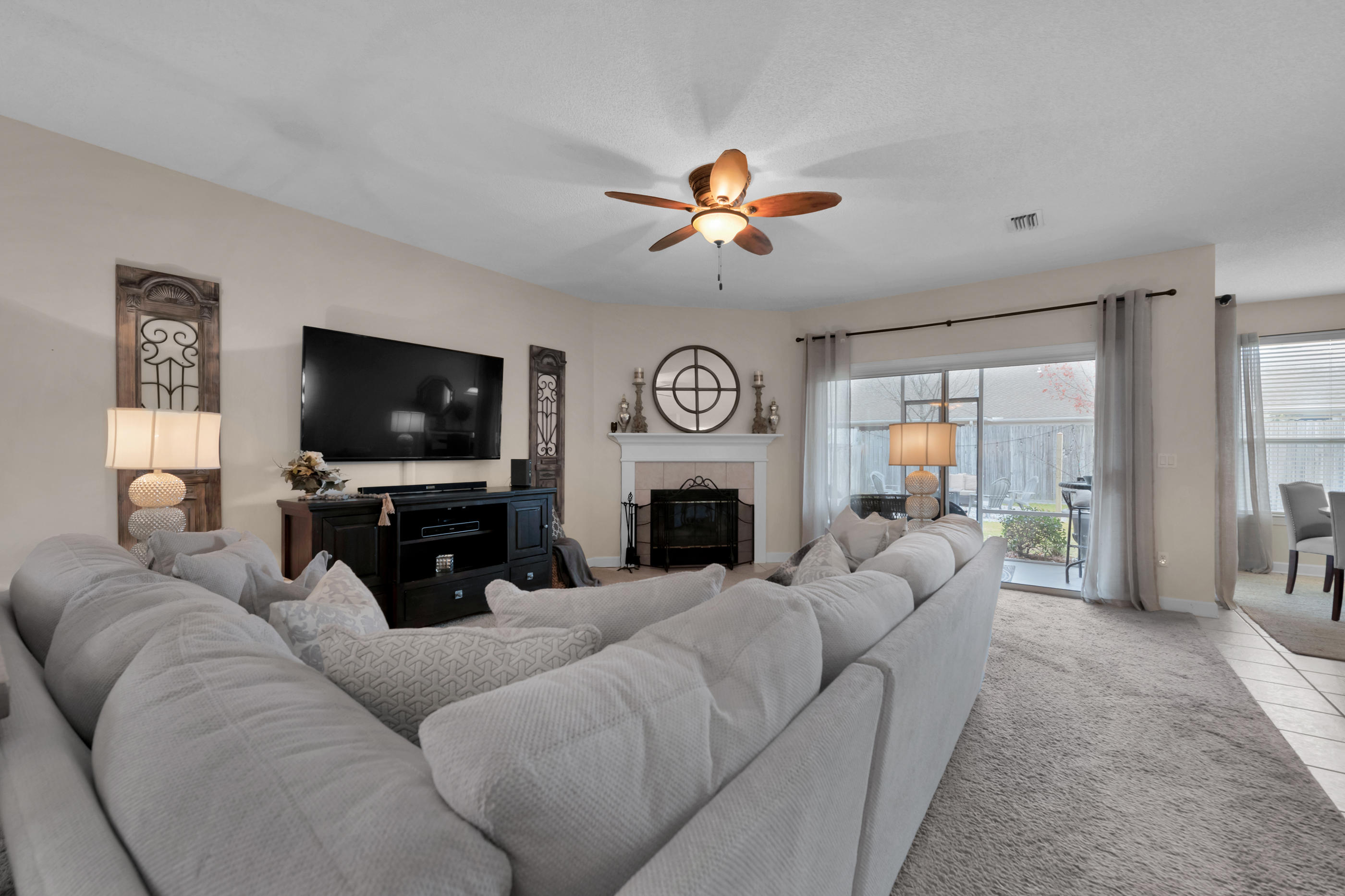 4061 Drifting Sand Trail Destin, FL 32541 - Photo 22 of 32 a living room with furniture a flat screen tv and a fireplace