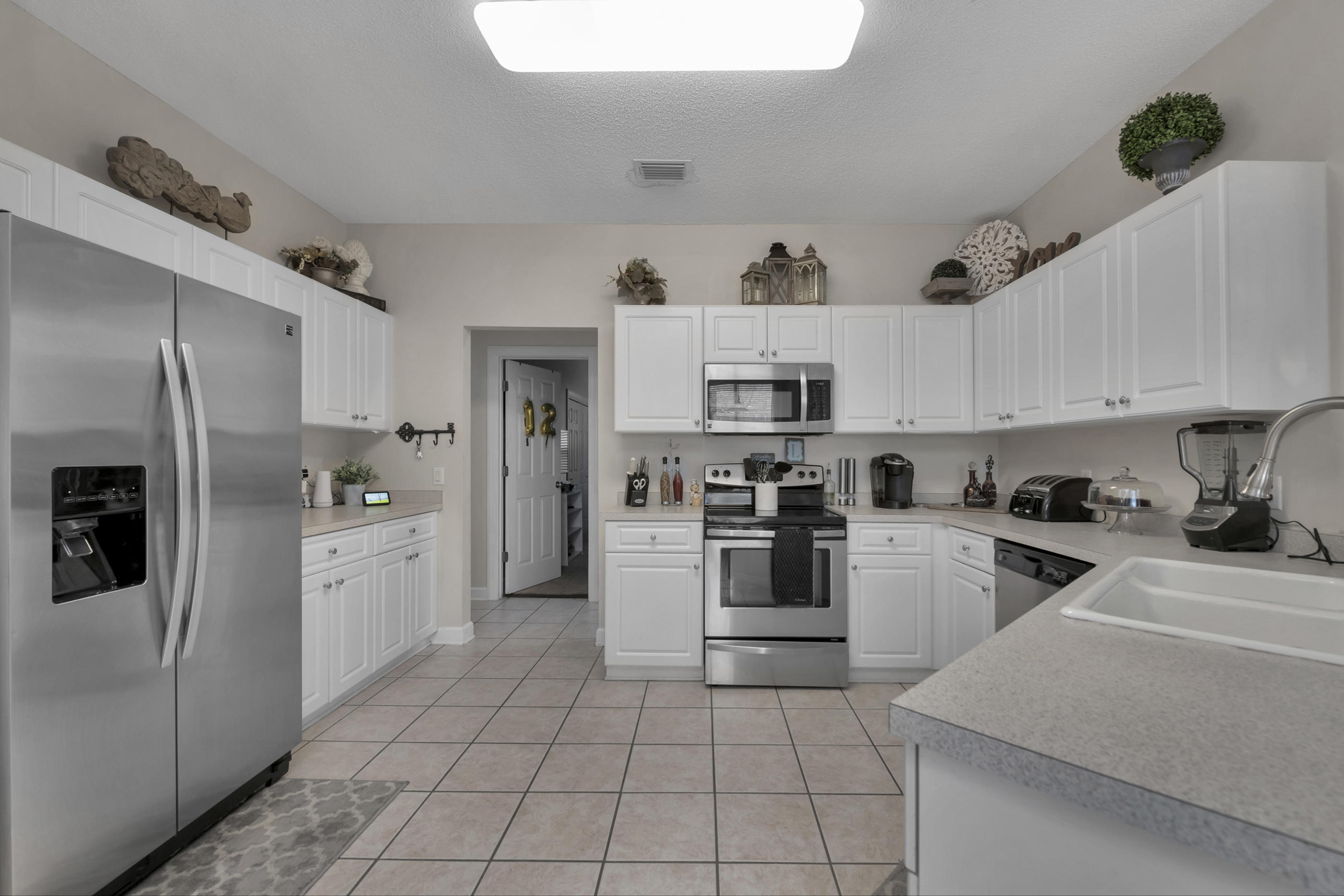 4061 Drifting Sand Trail Destin, FL 32541 - Photo 23 of 32 a kitchen with cabinets and stainless steel appliances