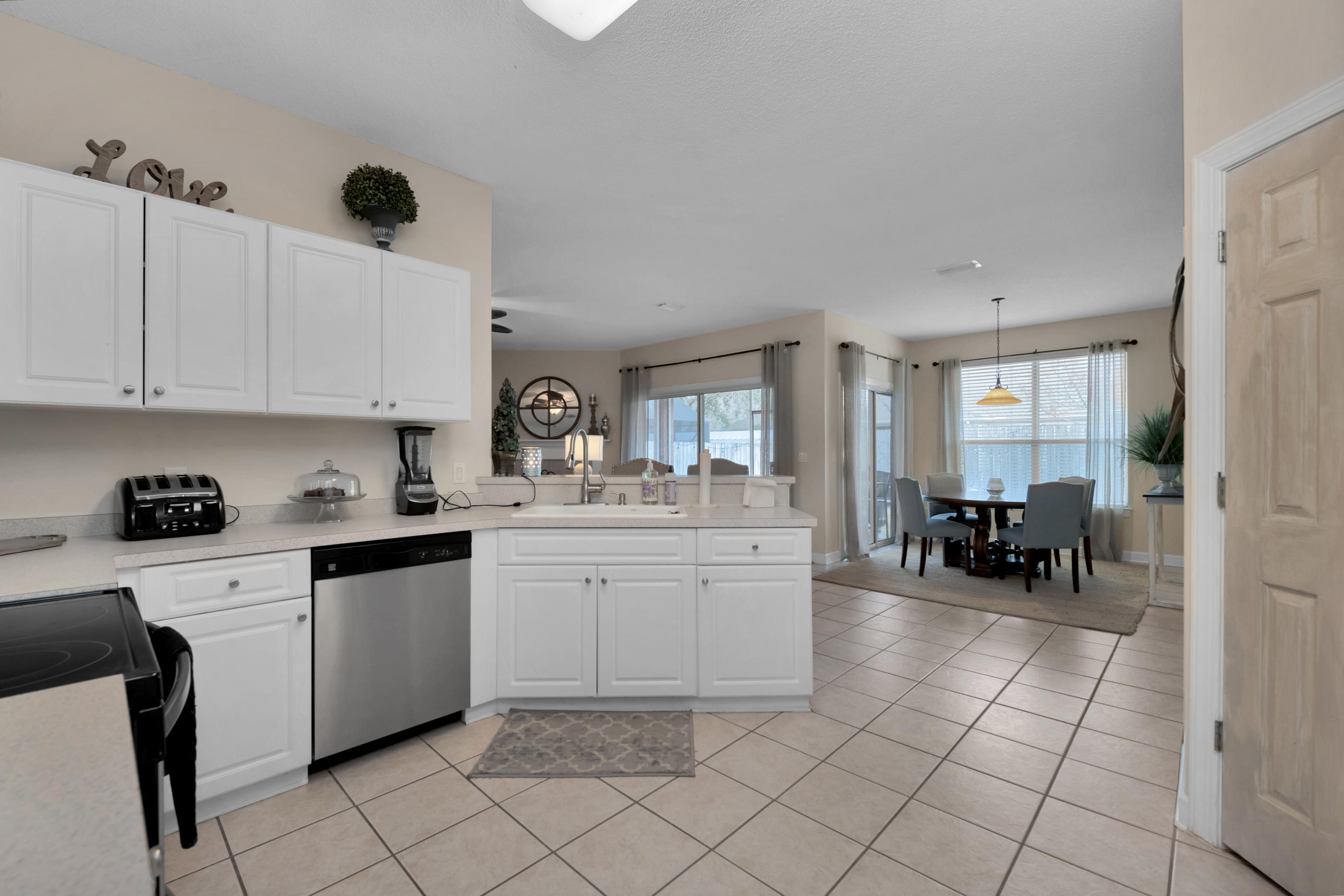 4061 Drifting Sand Trail Destin, FL 32541 - Photo 24 of 32 a kitchen with a sink and chairs