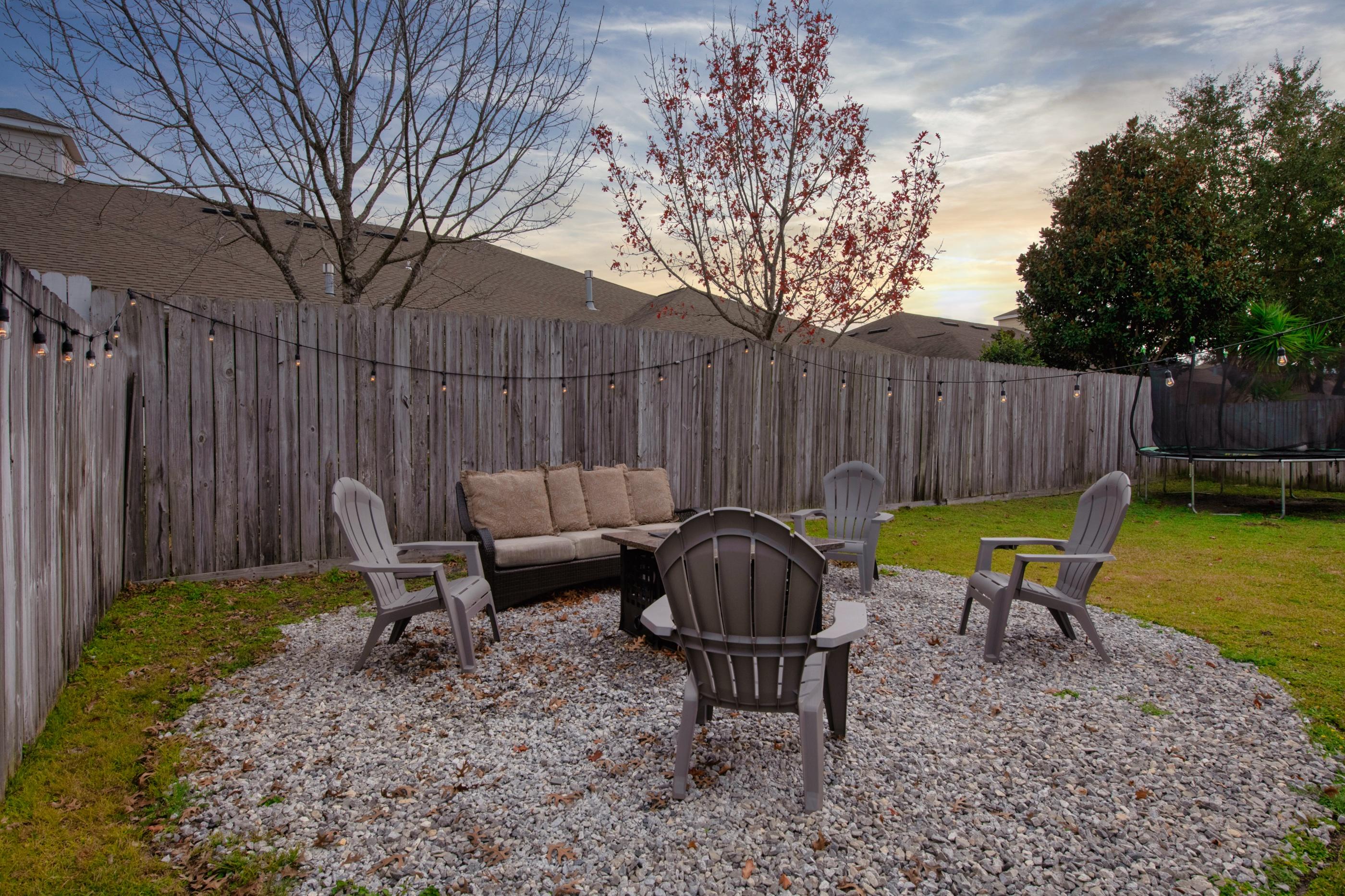 4061 Drifting Sand Trail Destin, FL 32541 - Photo 27 of 32 a backyard of a house with table and chairs