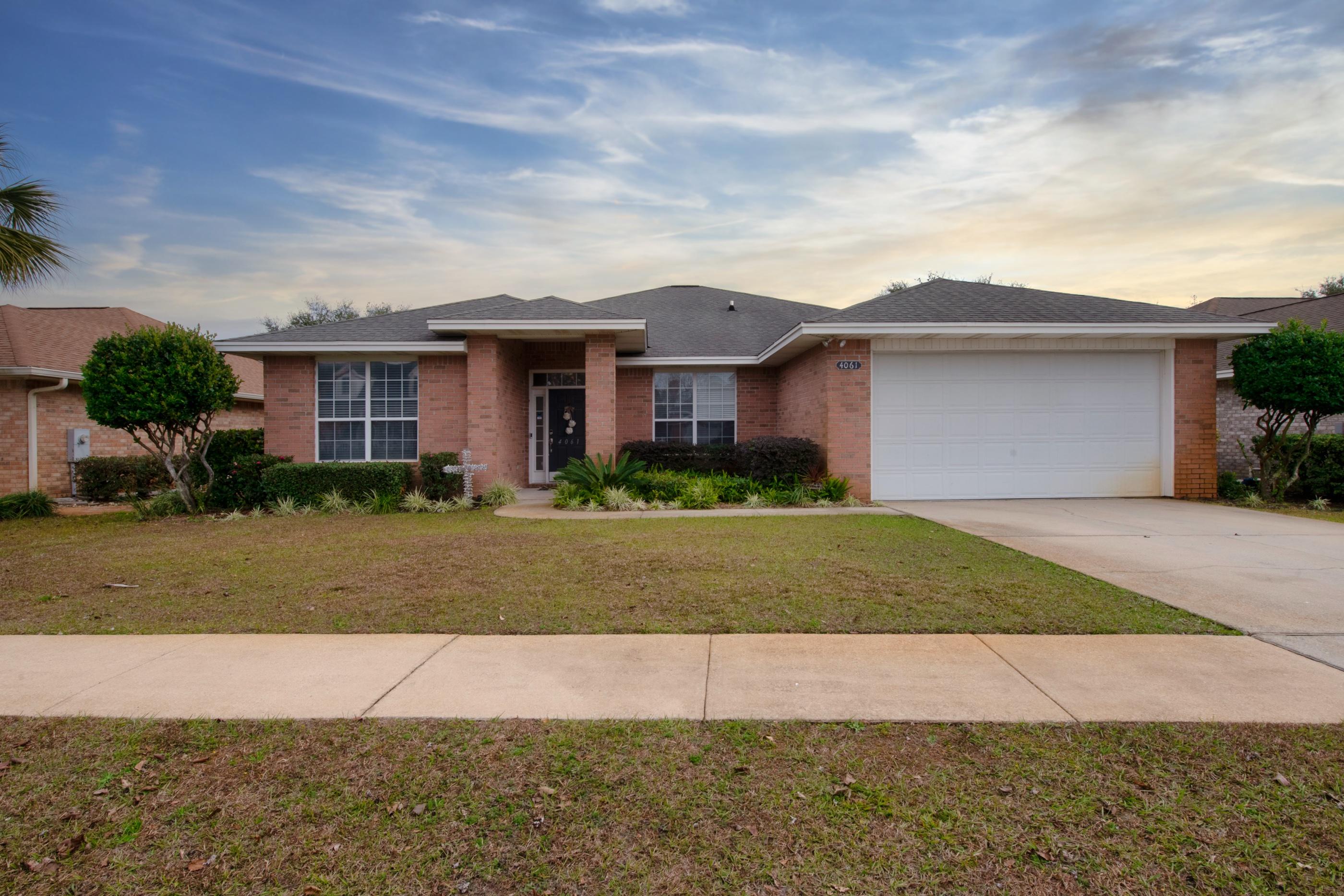 4061 Drifting Sand Trail Destin, FL 32541 - Photo 3 of 32 a front view of a house with a yard and garage