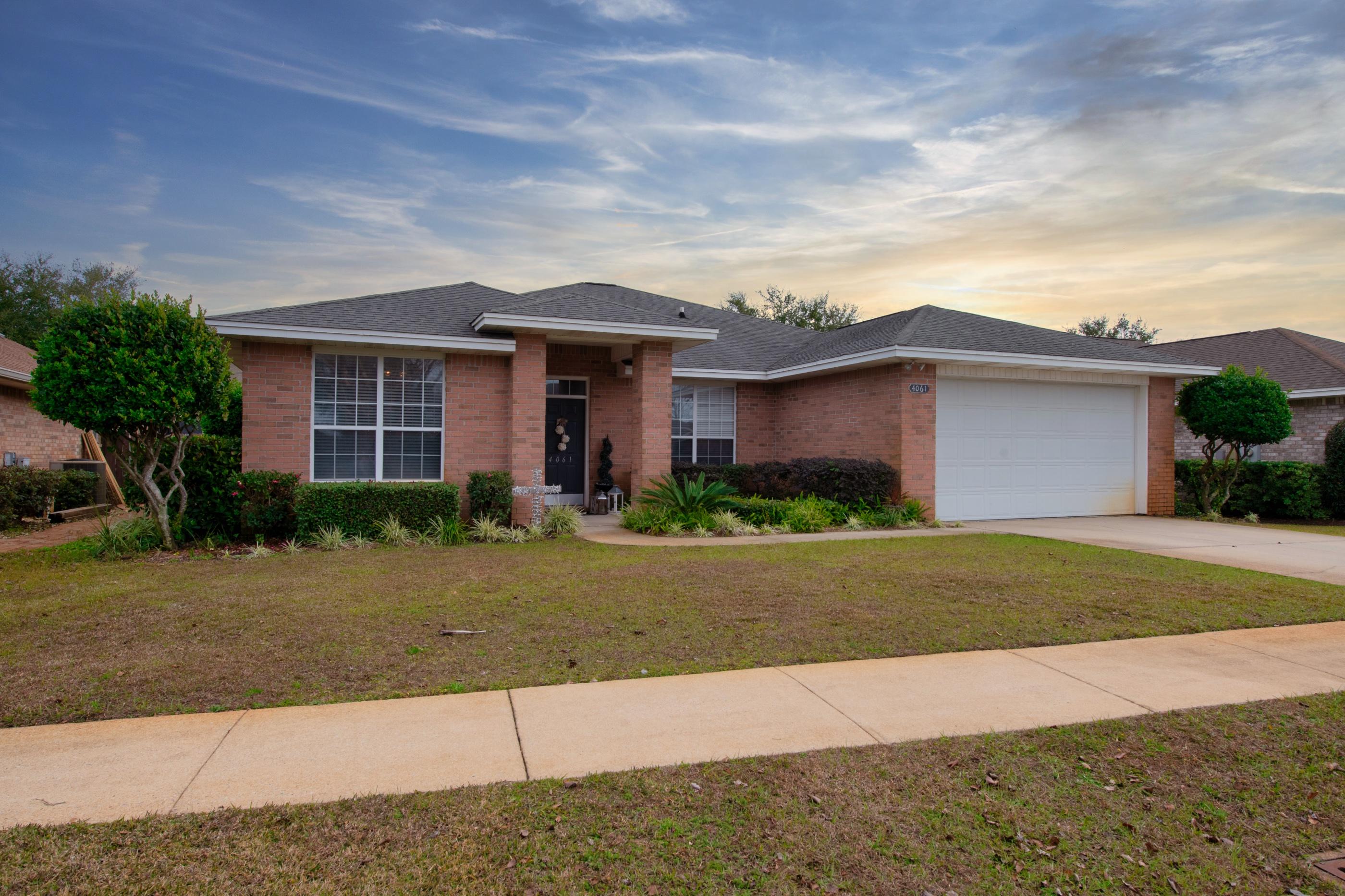 4061 Drifting Sand Trail Destin, FL 32541 - Photo 4 of 32 a front view of a house with a yard and garage