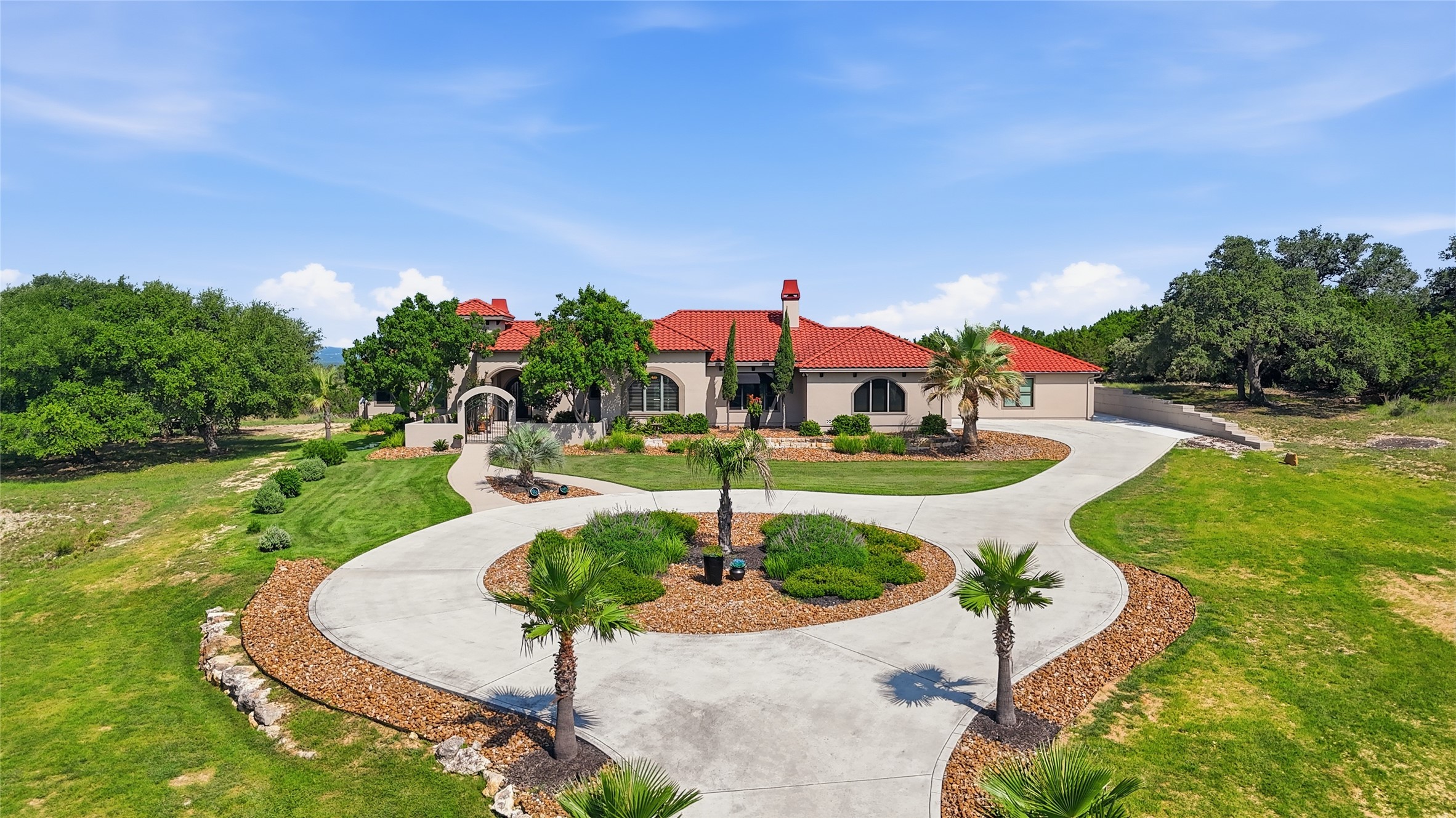 228 Puzzle Pass Spring Branch, TX 78070 - Photo 3 of 35 An estate-worthy arrival featuring a grand circular motor court, resort-inspired landscaping, and undeniable wow-factor.