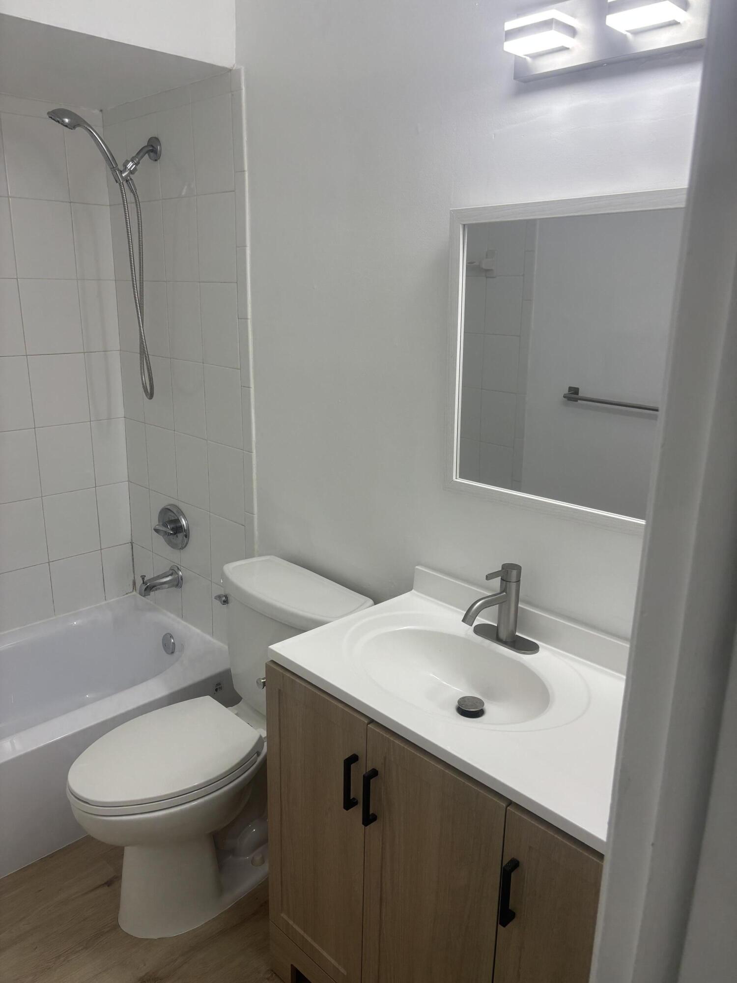 521 Northeast 45th Street Boca Raton, FL 33431 - Photo 14 of 17 a bathroom with a sink a toilet and shower