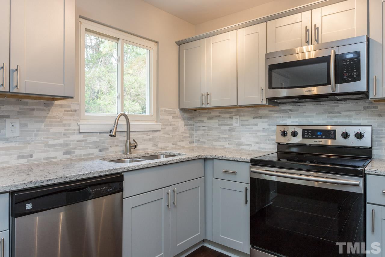 2708 Sanderford Road Raleigh, NC 27610 - Photo 2 of 21 a kitchen with a sink stove and microwave